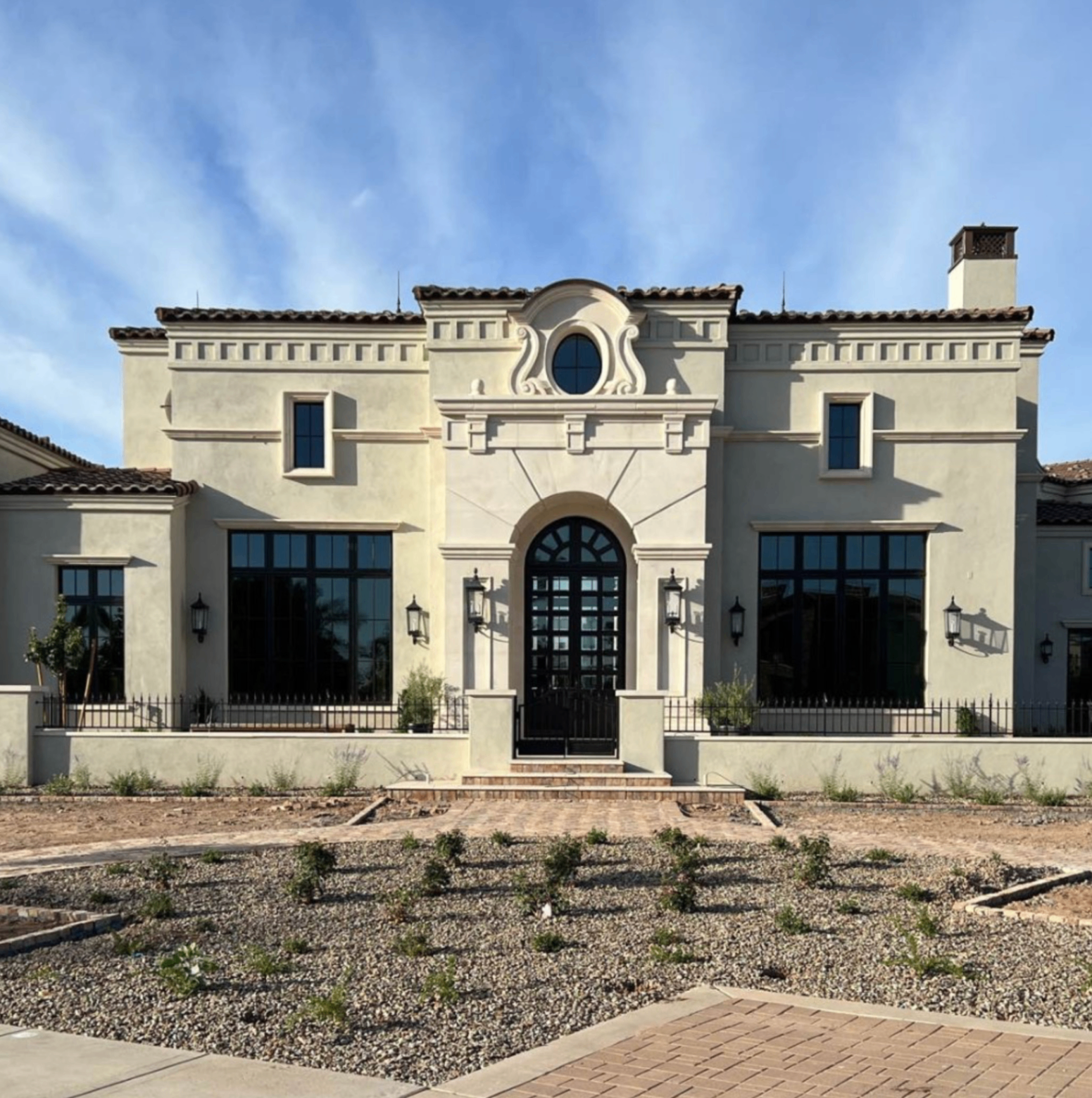 Classic estate facade with grand entry and architectural detailing.
