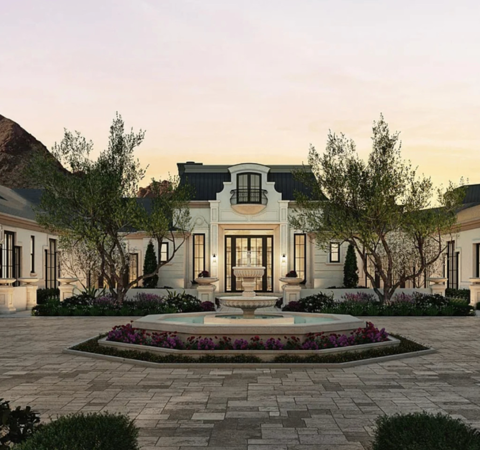 Symmetrical estate courtyard with fountain and landscaped approach.